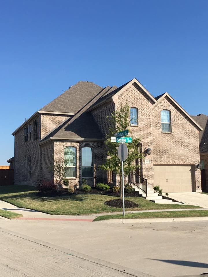 Two-story brick home on a corner lot with a new roof