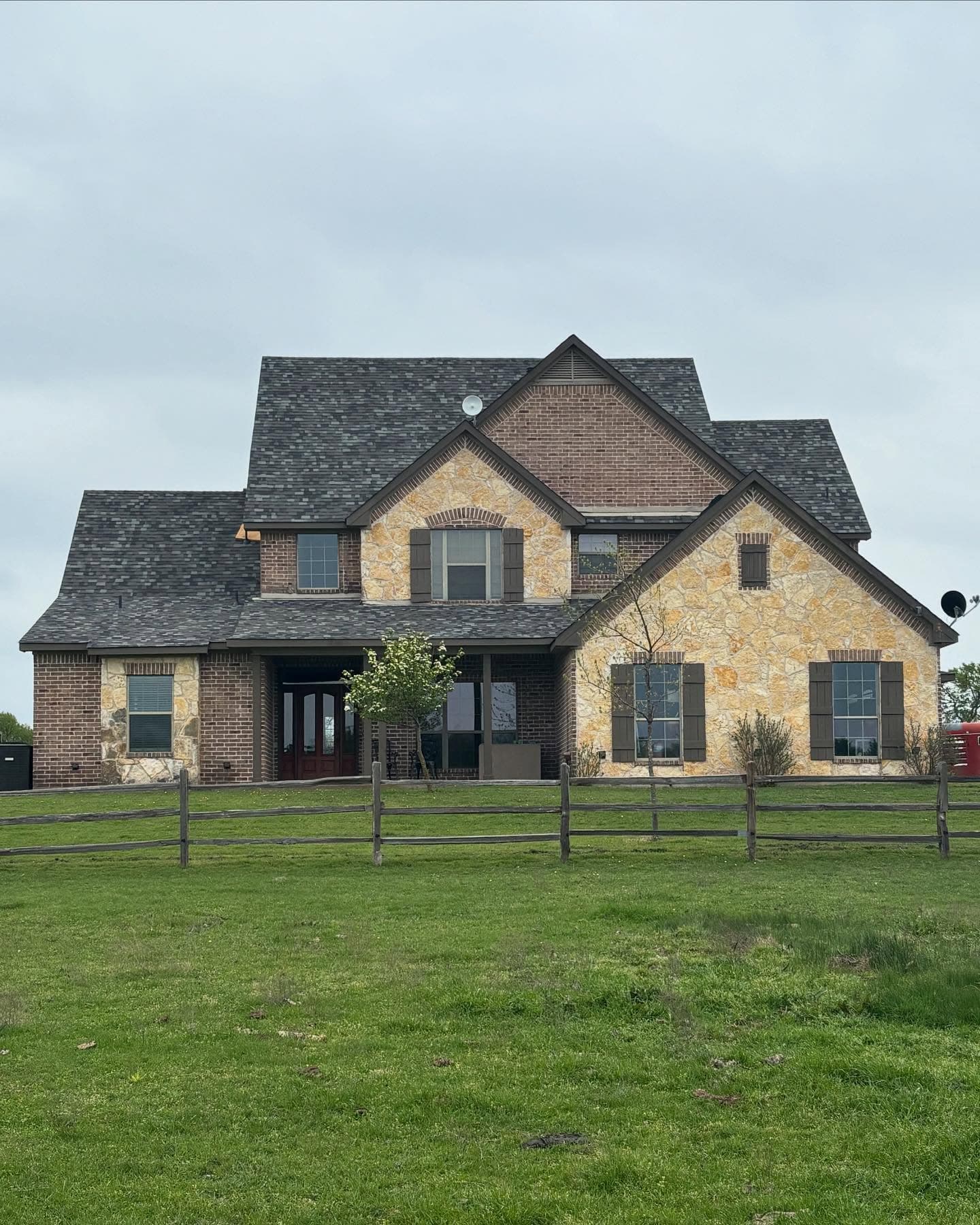 Stone and brick home with a new architectural shingle roof